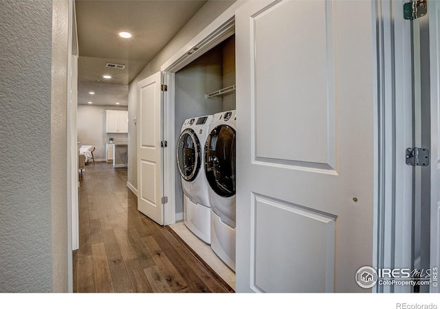410 High Point Dr Unit 102, Longmont, CO 80504 - washroom with washing machine and dryer, hardwood / wood-style floors, and recessed lighting