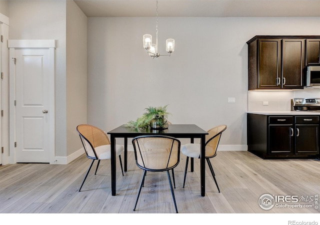 4173 Trapper Lake Dr, Loveland, CO 80538 - dining room featuring light wood-style floors, a chandelier, and baseboards