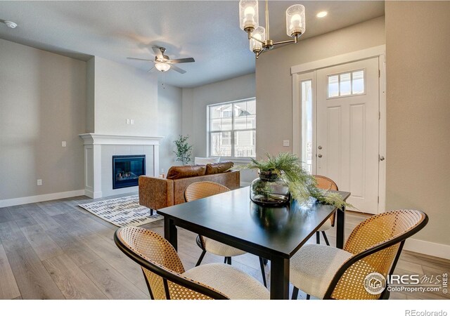 4173 Trapper Lake Dr, Loveland, CO 80538 - dining space featuring plenty of natural light, ceiling fan, baseboards, light wood-style floors, and recessed lighting