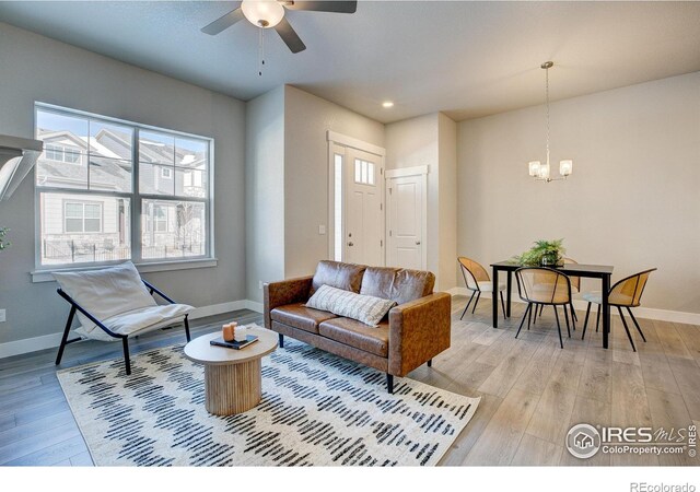 4173 Trapper Lake Dr, Loveland, CO 80538 - living room with a ceiling fan, a chandelier, light wood finished floors, baseboards, and recessed lighting