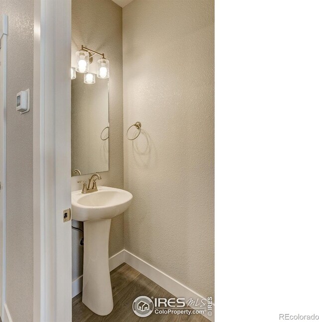 4173 Trapper Lake Dr, Loveland, CO 80538 - bathroom with wood finished floors and baseboards