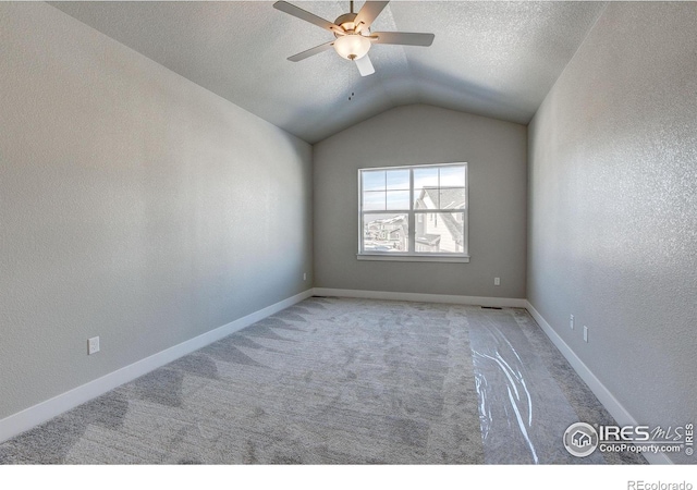 4173 Trapper Lake Dr, Loveland, CO 80538 - carpeted empty room featuring vaulted ceiling, a ceiling fan, and a textured ceiling