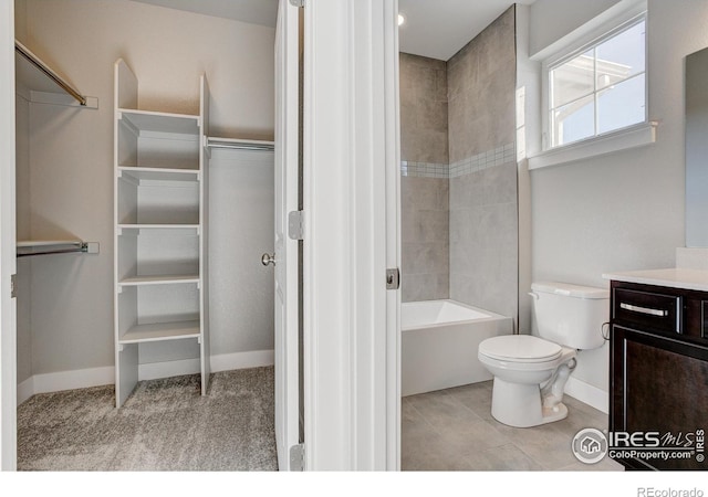 4173 Trapper Lake Dr, Loveland, CO 80538 - bathroom featuring vanity, toilet, baseboards, a walk in closet, and shower / bathtub combination