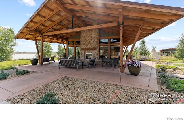 4173 Trapper Lake Dr, Loveland, CO 80538 - view of patio with a gazebo, an outdoor living space, and a water view