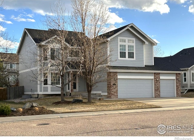 5603 Pierson Mountain Ave, Longmont, CO 80503 - traditional home featuring brick siding, driveway, and a garage