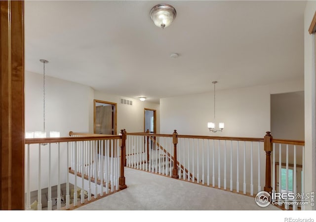 5603 Pierson Mountain Ave, Longmont, CO 80503 - hallway featuring carpet, an upstairs landing, and a chandelier