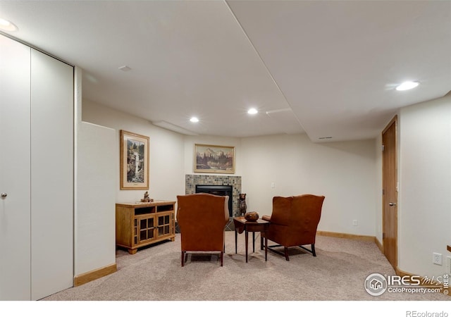 5603 Pierson Mountain Ave, Longmont, CO 80503 - sitting room with light colored carpet, a tiled fireplace, recessed lighting, and baseboards