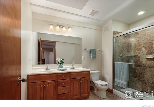 5603 Pierson Mountain Ave, Longmont, CO 80503 - bathroom with double vanity, a shower stall, toilet, and tile patterned floors