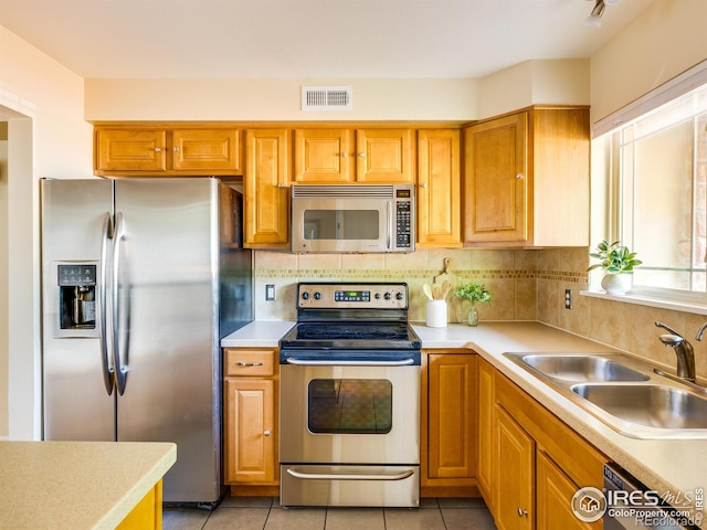 4800 Osage Dr Unit 12B, Boulder, CO 80303 - kitchen featuring appliances with stainless steel finishes, a sink, light countertops, and light tile patterned flooring