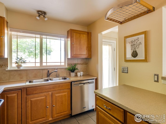 4800 Osage Dr Unit 12B, Boulder, CO 80303 - kitchen featuring dishwasher, a sink, tasteful backsplash, and brown cabinetry