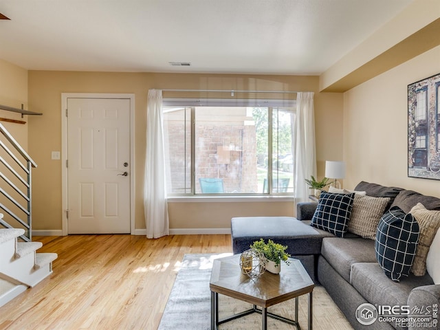 4800 Osage Dr Unit 12B, Boulder, CO 80303 - living room featuring stairway, wood finished floors, and baseboards