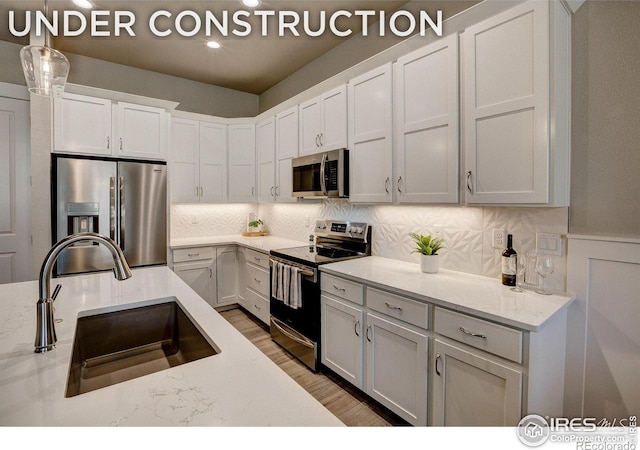 218 High Point Dr, Longmont, CO 80504 - kitchen with appliances with stainless steel finishes, a sink, decorative backsplash, white cabinetry, and recessed lighting