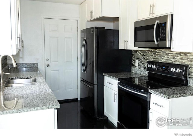 15532 E Pacific Pl, Aurora, CO 80013 - kitchen featuring stainless steel microwave, electric range, a sink, white cabinets, and backsplash