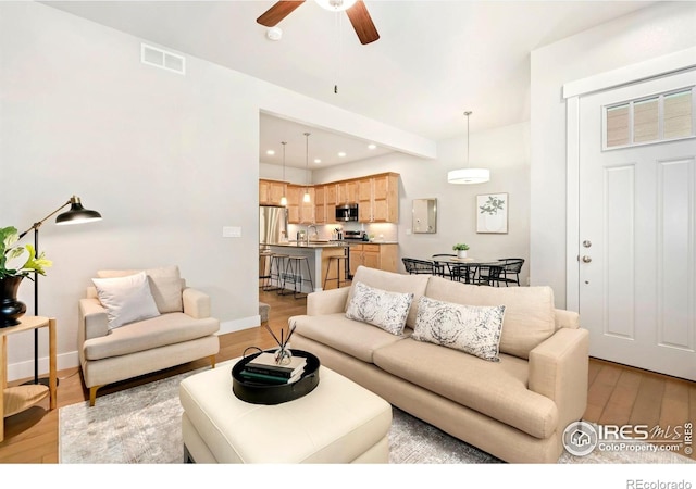 1810 W 50th St, Loveland, CO 80538 - living area featuring light wood-type flooring, ceiling fan, baseboards, and recessed lighting