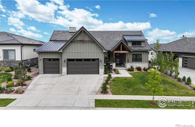2790 Heron Lakes Pkwy, Berthoud, CO 80513 - view of front of house featuring board and batten siding, an attached garage, driveway, a front lawn, and stone siding