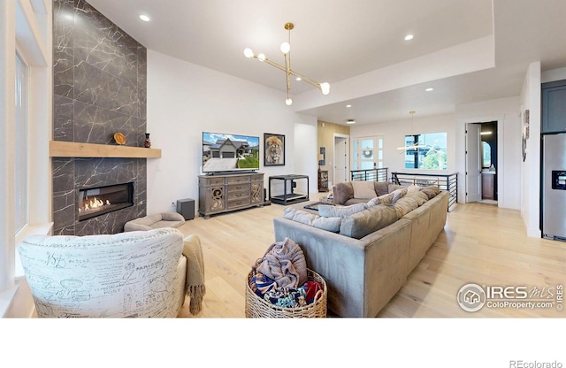 2790 Heron Lakes Pkwy, Berthoud, CO 80513 - living area with light wood-style flooring, recessed lighting, a fireplace, and a chandelier