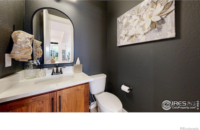 2790 Heron Lakes Pkwy, Berthoud, CO 80513 - bathroom featuring a textured wall, toilet, and vanity