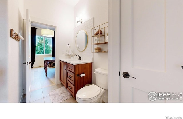 2790 Heron Lakes Pkwy, Berthoud, CO 80513 - bathroom featuring vanity, toilet, and tile patterned floors
