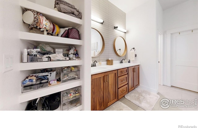 2790 Heron Lakes Pkwy, Berthoud, CO 80513 - full bathroom with tile patterned floors, double vanity, and backsplash