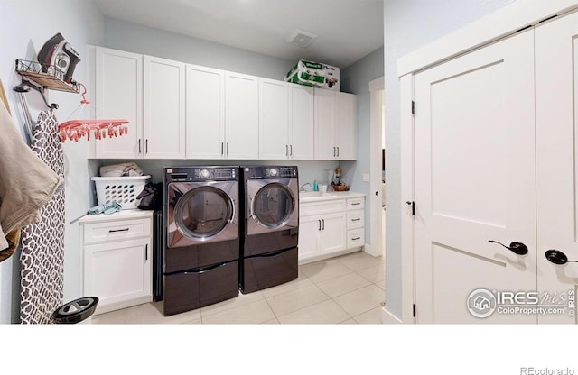 2790 Heron Lakes Pkwy, Berthoud, CO 80513 - washroom featuring washing machine and clothes dryer, cabinet space, and light tile patterned floors