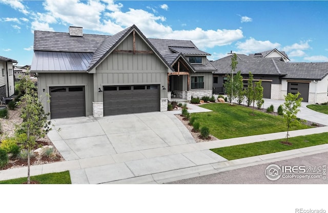 2790 Heron Lakes Pkwy, Berthoud, CO 80513 - view of front facade featuring board and batten siding, an attached garage, a front yard, concrete driveway, and stone siding