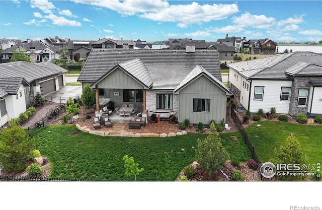 2790 Heron Lakes Pkwy, Berthoud, CO 80513 - back of property with board and batten siding, a residential view, a patio, and a yard