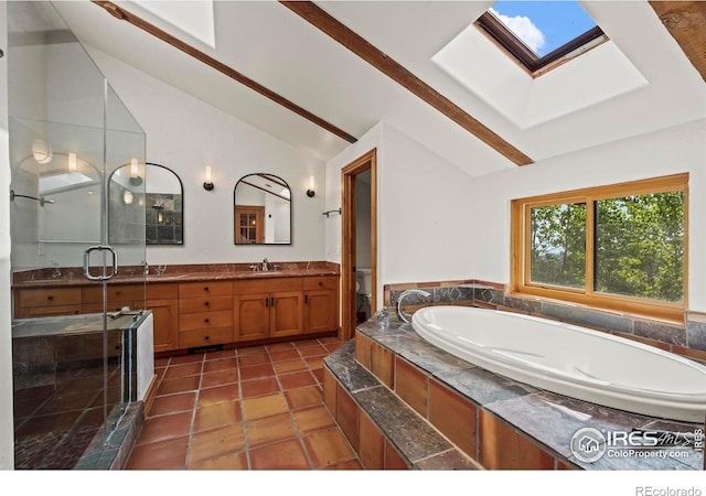 172 Tall Pine Ln, Boulder, CO 80302 - bathroom featuring a skylight, vaulted ceiling, a garden tub, double vanity, and a stall shower