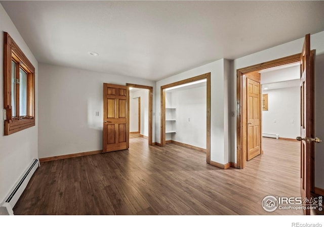 172 Tall Pine Ln, Boulder, CO 80302 - unfurnished room featuring a baseboard radiator, wood finished floors, baseboards, and recessed lighting