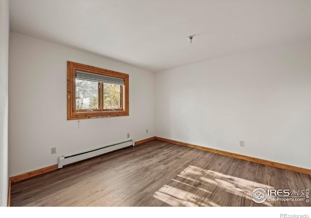 172 Tall Pine Ln, Boulder, CO 80302 - spare room with a baseboard radiator, wood finished floors, and baseboards