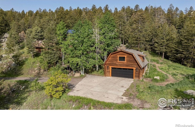 172 Tall Pine Ln, Boulder, CO 80302 - garage with a view of trees, a detached garage, and driveway