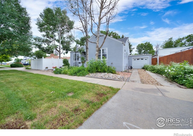 614 E Beaver Ave, Fort Morgan, CO 80701 - view of front facade with stucco siding, driveway, and a garage