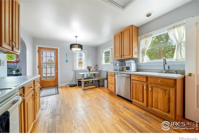 614 E Beaver Ave, Fort Morgan, CO 80701 - kitchen featuring stainless steel dishwasher, light wood-style flooring, white range with electric stovetop, light countertops, and a sink