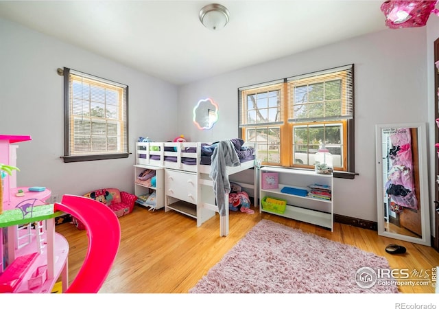 614 E Beaver Ave, Fort Morgan, CO 80701 - bedroom with multiple windows and wood finished floors