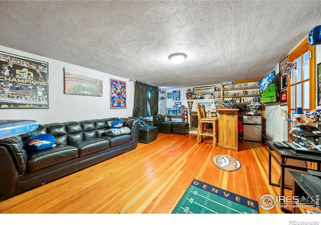 614 E Beaver Ave, Fort Morgan, CO 80701 - living room featuring wood finished floors and a textured ceiling