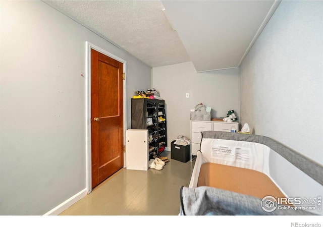 614 E Beaver Ave, Fort Morgan, CO 80701 - bedroom featuring baseboards and a textured ceiling