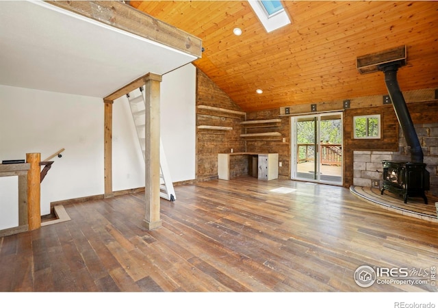 90 California Gulch Rd, Jamestown, CO 80455 - unfurnished living room featuring a wood stove, hardwood / wood-style flooring, a skylight, high vaulted ceiling, and wooden ceiling