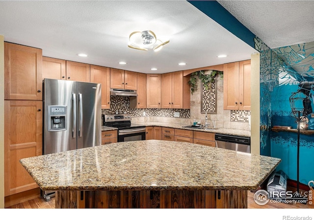14000 E Linvale Pl Unit 210, Aurora, CO 80014 - kitchen featuring appliances with stainless steel finishes, a sink, light stone countertops, decorative backsplash, and recessed lighting