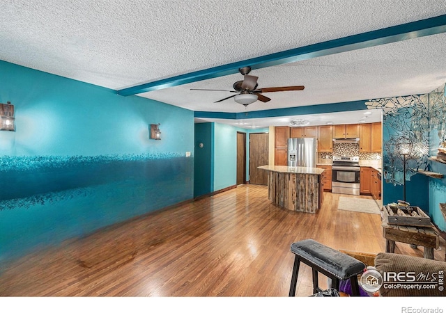 14000 E Linvale Pl Unit 210, Aurora, CO 80014 - living room featuring light wood-style flooring, ceiling fan, beam ceiling, and a textured ceiling