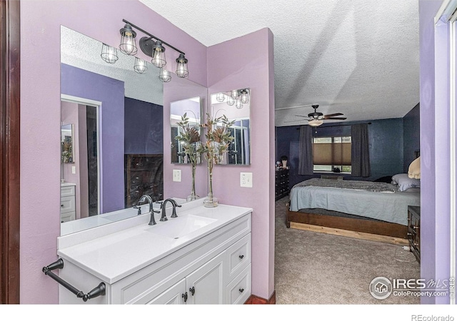 14000 E Linvale Pl Unit 210, Aurora, CO 80014 - ensuite bathroom featuring a textured ceiling, vanity, and a ceiling fan