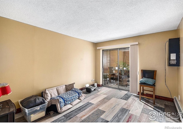 14000 E Linvale Pl Unit 210, Aurora, CO 80014 - bedroom with access to exterior, wood finished floors, a textured ceiling, a baseboard radiator, and baseboards