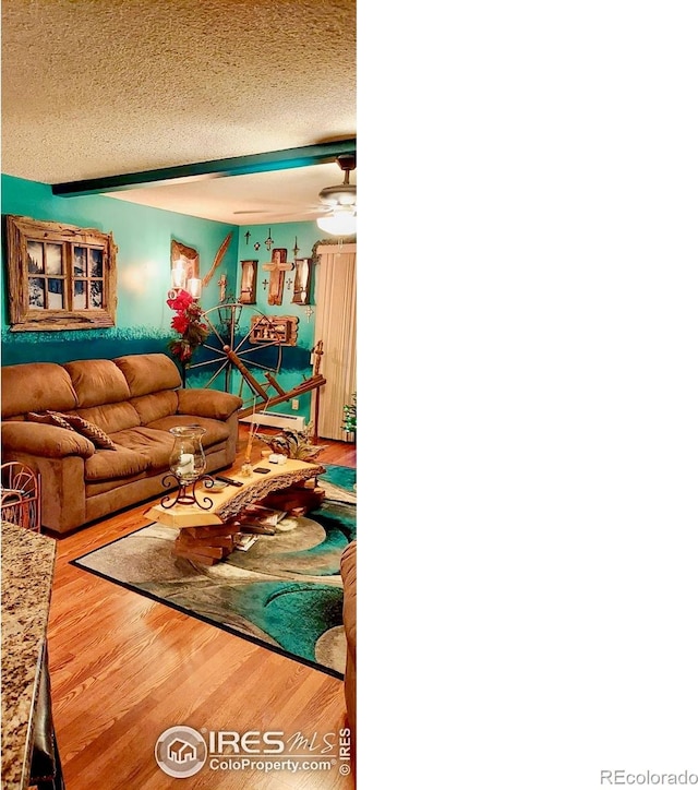 14000 E Linvale Pl Unit 210, Aurora, CO 80014 - living area featuring wood finished floors, a textured ceiling, a baseboard radiator, and a ceiling fan