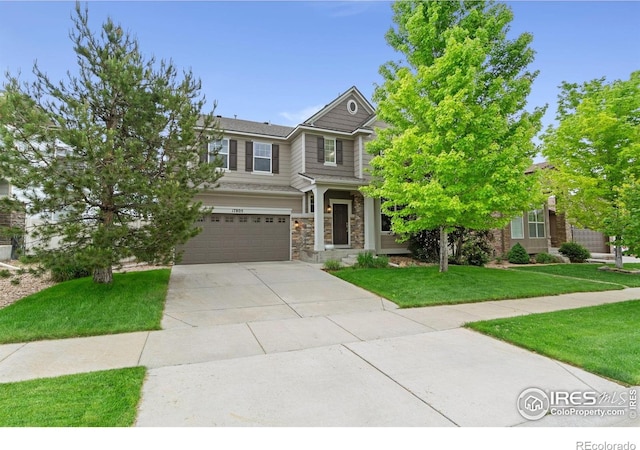 17805 Coral Burst St, Parker, CO 80134 - view of front of home featuring a garage, a front yard, concrete driveway, and stone siding