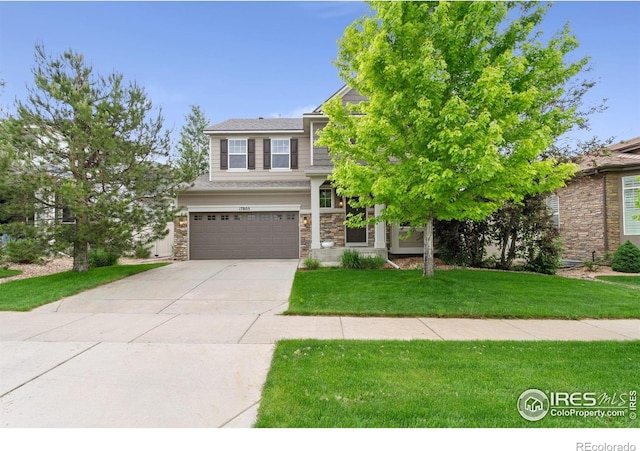 17805 Coral Burst St, Parker, CO 80134 - view of front facade featuring stone siding, a garage, driveway, and a front yard