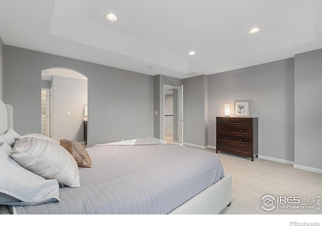17805 Coral Burst St, Parker, CO 80134 - bedroom with light carpet, arched walkways, recessed lighting, baseboards, and a raised ceiling