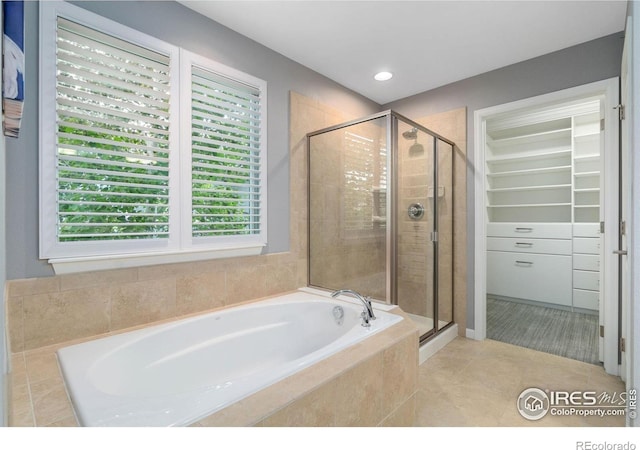 17805 Coral Burst St, Parker, CO 80134 - full bathroom with a garden tub, a stall shower, a spacious closet, tile patterned flooring, and recessed lighting