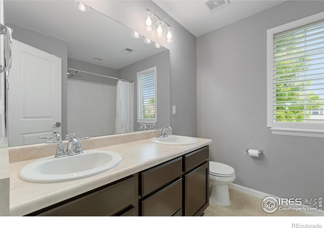 17805 Coral Burst St, Parker, CO 80134 - full bathroom featuring double vanity, toilet, baseboards, tile patterned floors, and curtained shower