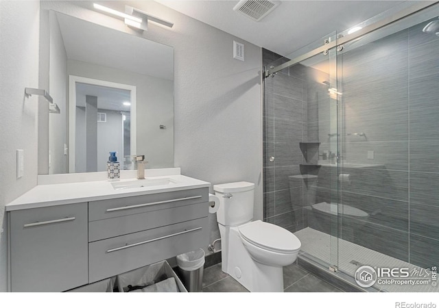 17805 Coral Burst St, Parker, CO 80134 - full bathroom with toilet, vanity, tile patterned flooring, and a stall shower