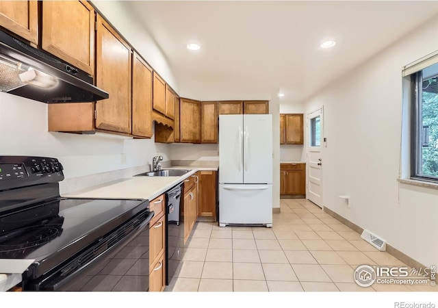 1025 Edinboro Dr, Boulder, CO 80305 - kitchen with black appliances, under cabinet range hood, a sink, brown cabinetry, and light countertops