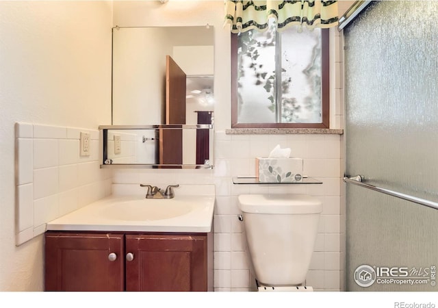 1025 Edinboro Dr, Boulder, CO 80305 - bathroom featuring vanity, tile walls, and toilet
