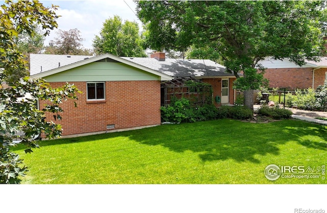 1025 Edinboro Dr, Boulder, CO 80305 - back of house with brick siding, a yard, a chimney, and crawl space